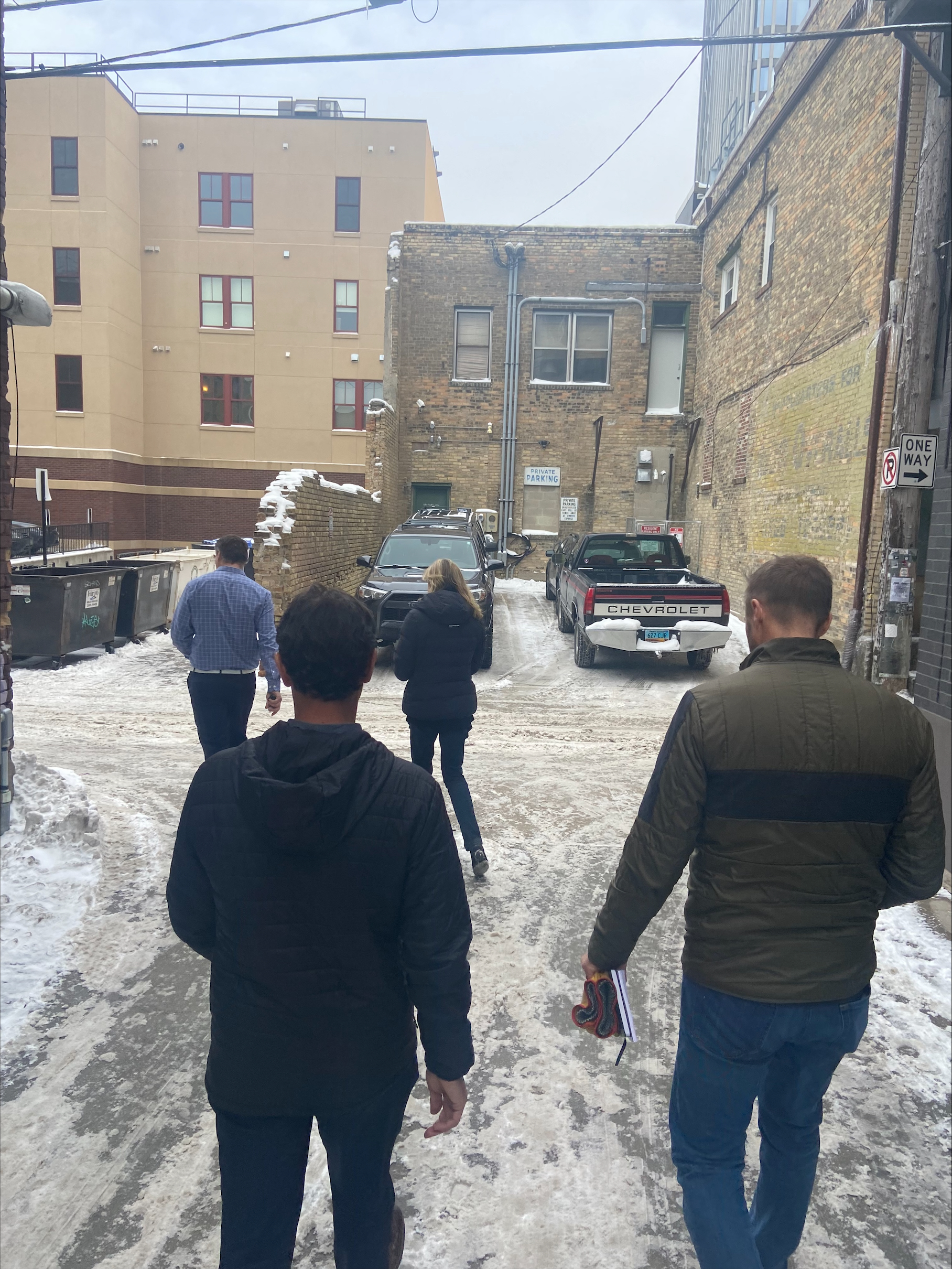 people walking down an alley in the winter